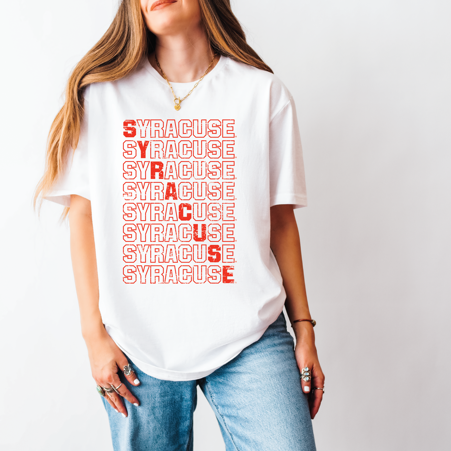 Model wearing white unisex t-shirt with bold red stacked “Syracuse” distressed graphic, styled with jeans and gold jewelry – Citrus Styles licensed SU apparel