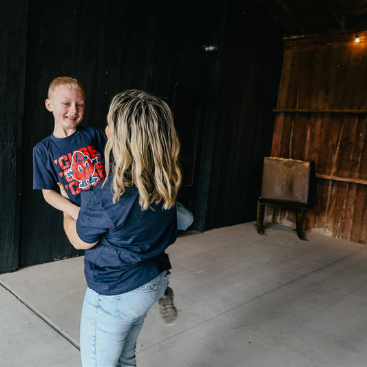 Boy laughing in navy Otto graphic tee for Syracuse