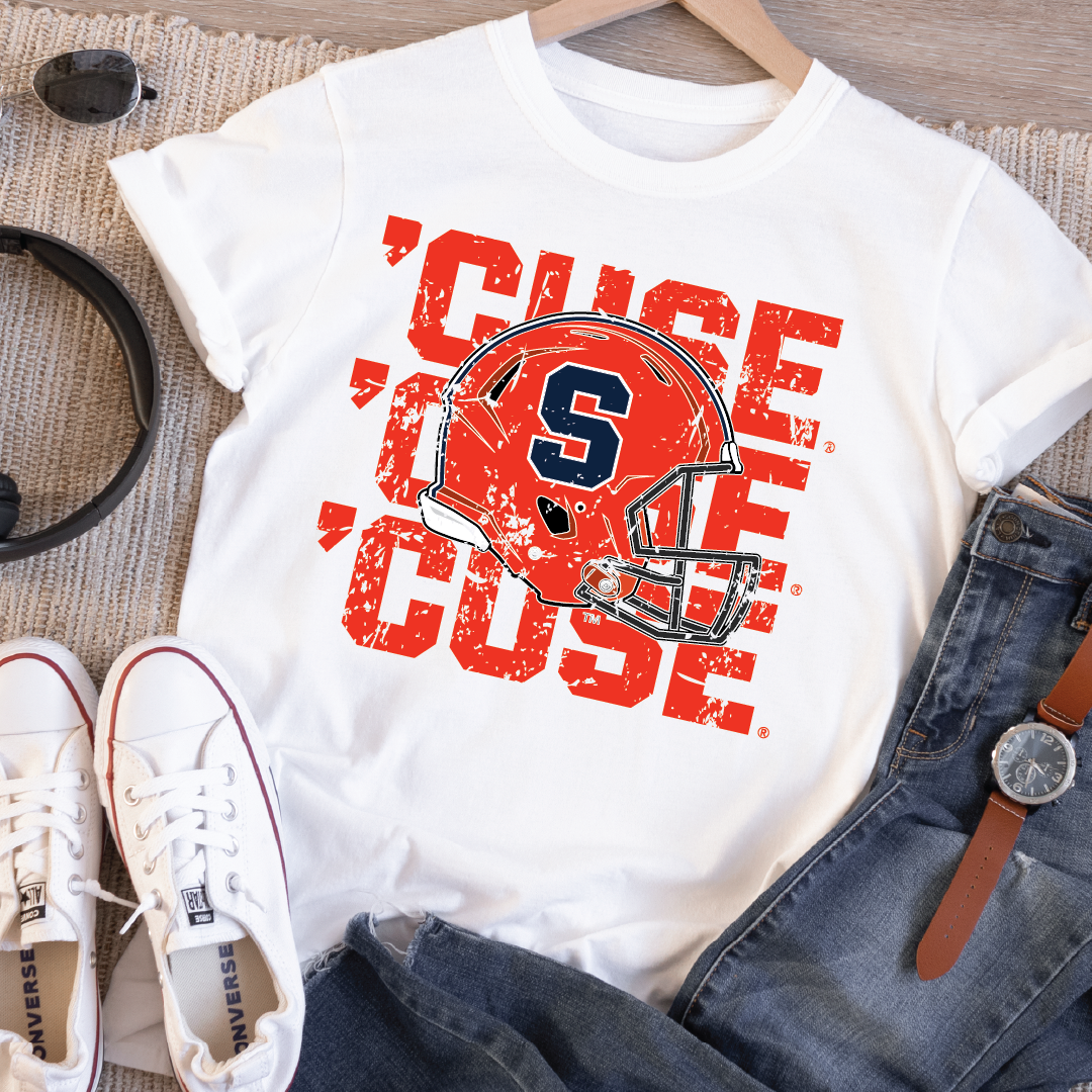 Flatlay of white unisex t-shirt featuring distressed triple ’CUSE text and Syracuse football helmet graphic – styled with jeans and Converse shoes